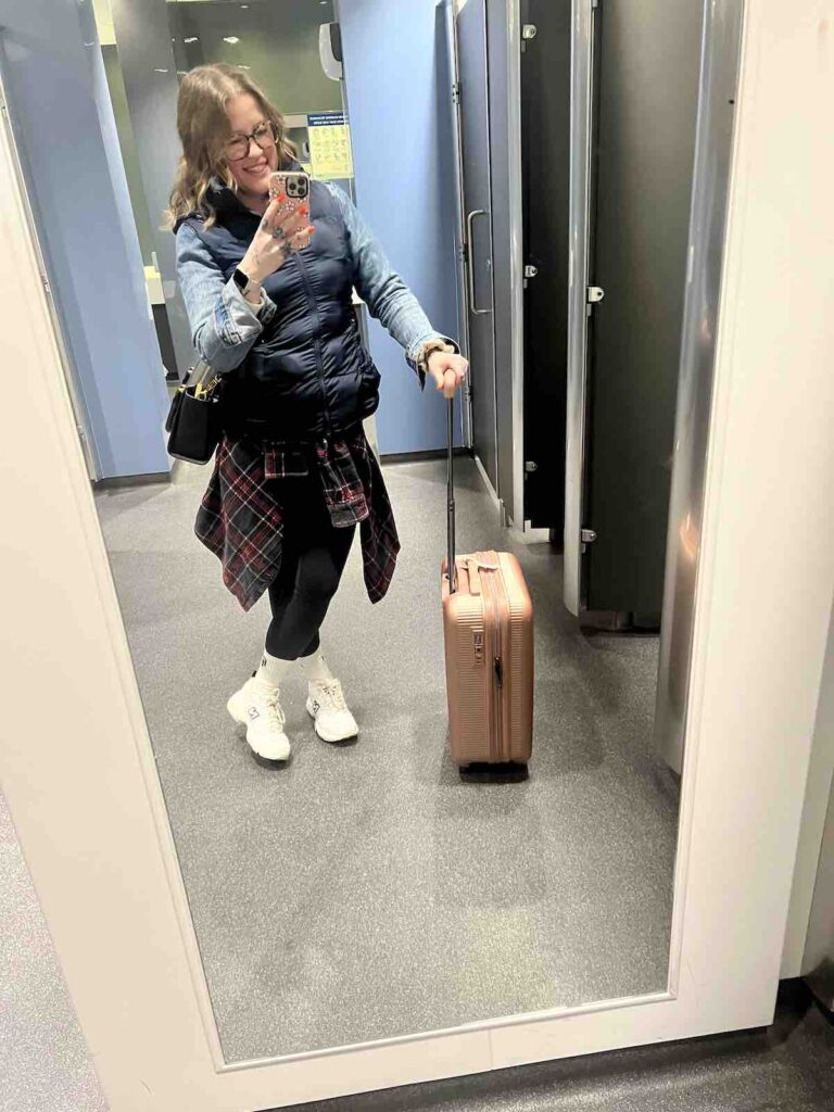 Hayley dressed in layers at the airport: England Travel Guide