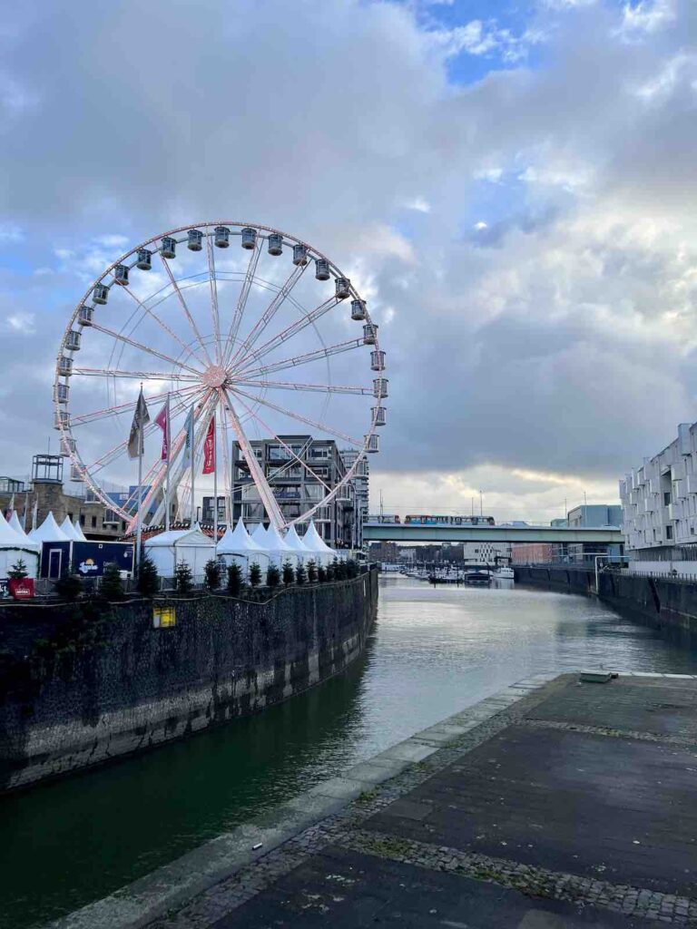 Christmas Market in Cologne: Harbour Market. View of the Ferris Wheel and river. 