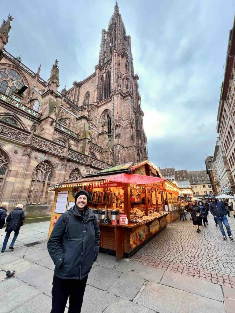 Trevor in front of the Place de Cathedral Christmas Market in Strasbourg